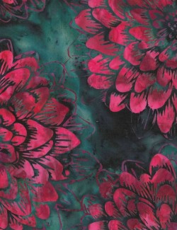 Batik fabric printed with large pink flowers on an emerald green backg