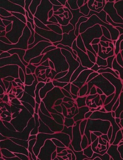 Batik fabric printed with pink flowers on a black background.