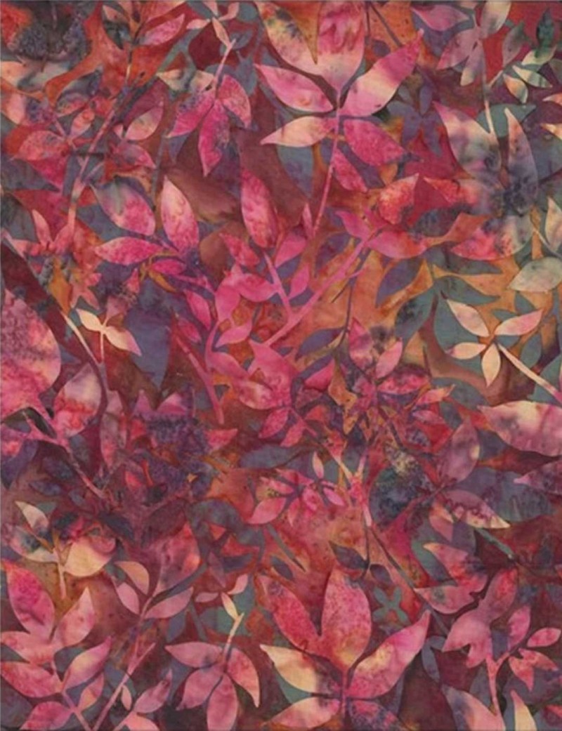 Batik fabric printed with colourful foliage in warm tones.